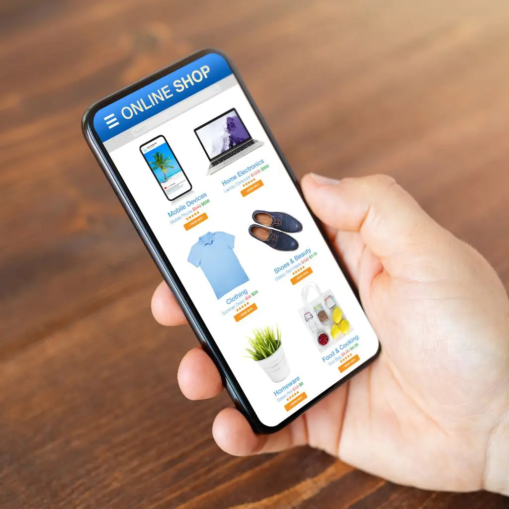 Hand holding mobile phone with online shopping site pulled up