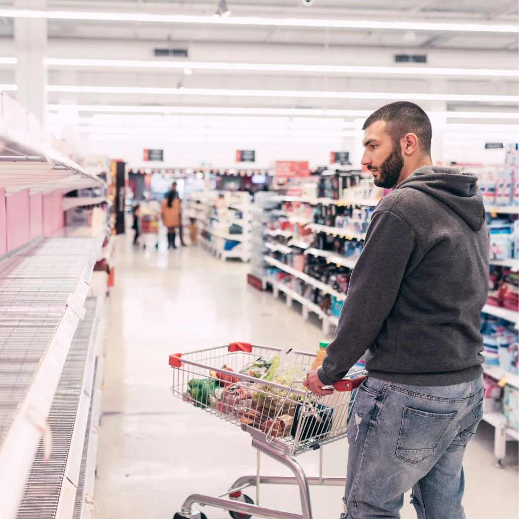 Man looking at store shelves while shopping